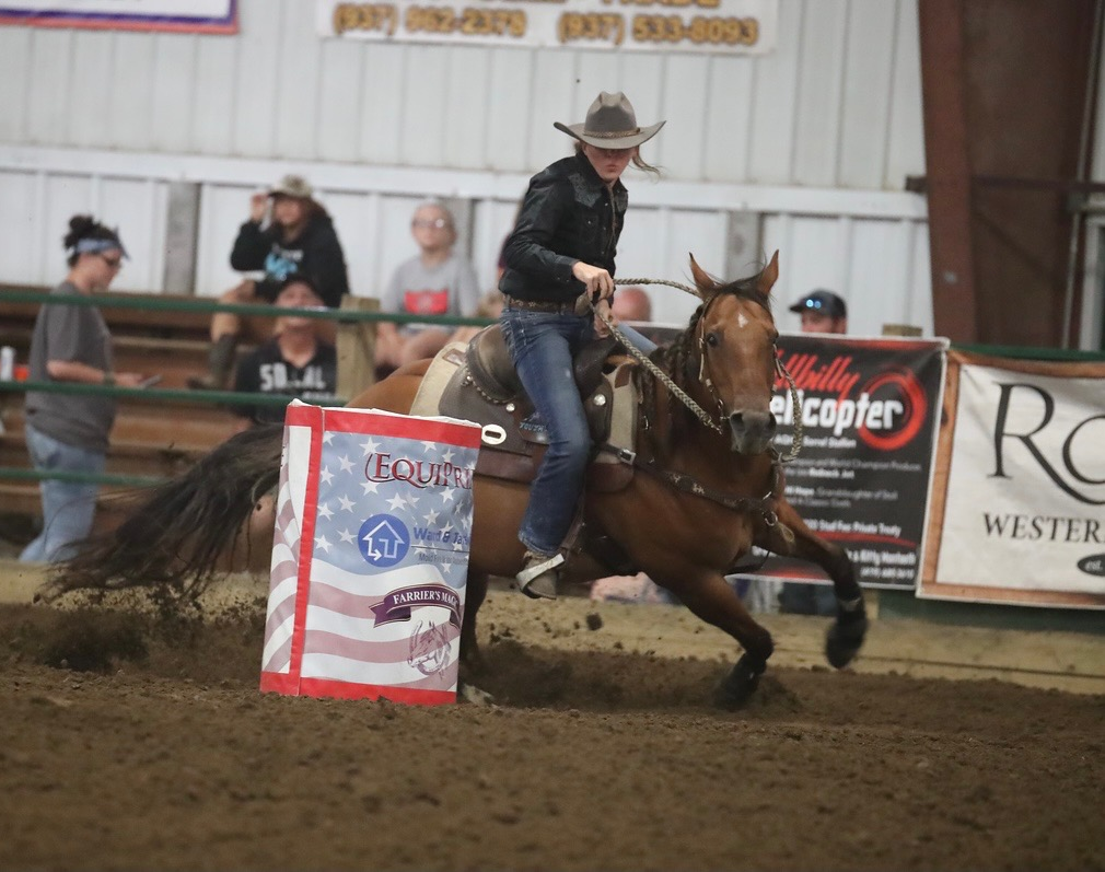 Barrel racer rounding a barrel at full speed